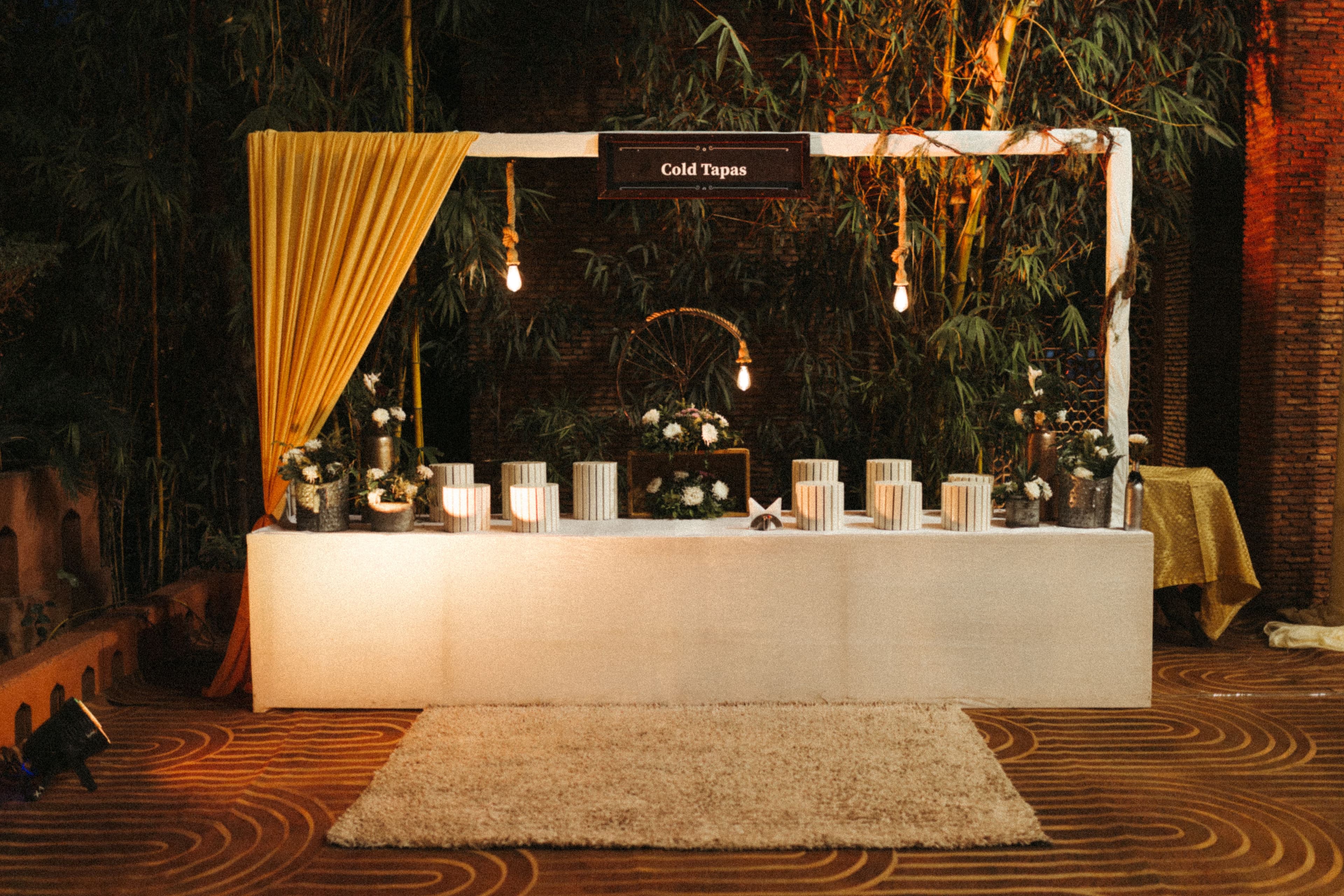 A sweeping, cinematic wide shot of a luxury outdoor wedding set at sunset on a grand, manicured lawn.
